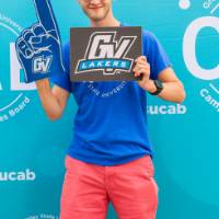 student posing  and holding foam finger and GV sign in front of CAB backdrop at Laker Kickoff photo booth